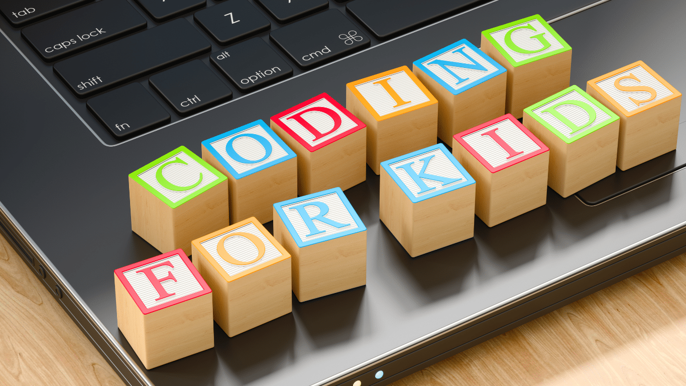 An image of an open laptop with multi colours letter blocks spelling out the phrase coding for kids.