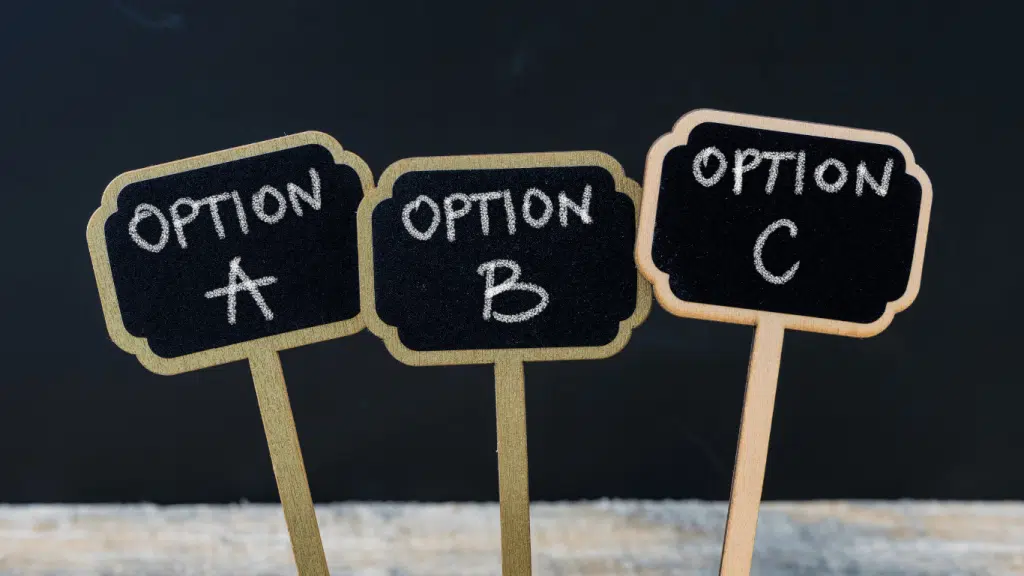 An image of three small signs against a black background. The small signed are labeled, Option 1, Options 2 and option 3. 