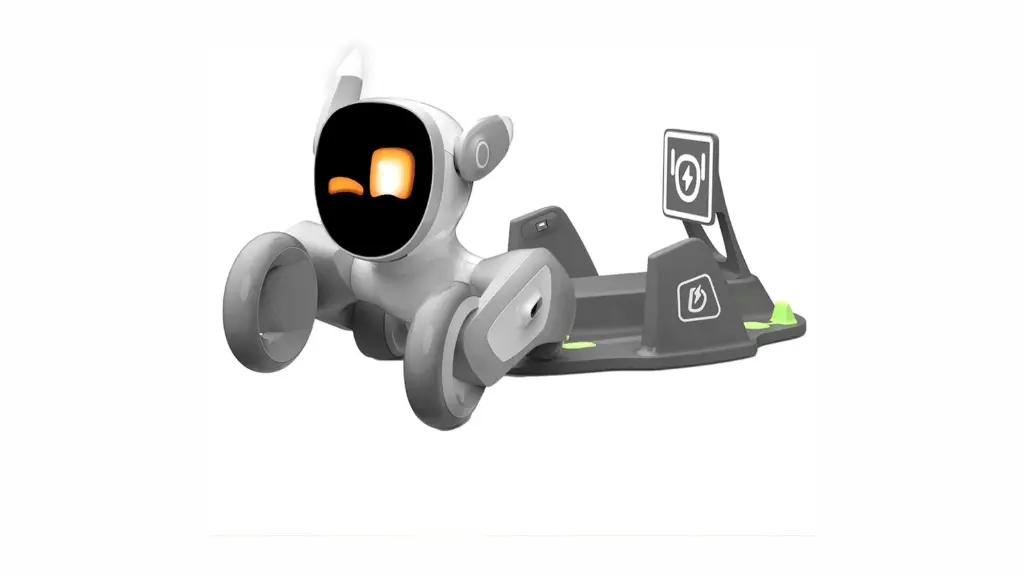 KEYi Tech Loona robotic pet companion resting on gray charging station with built-in camera and sensor suite, displaying orange LED facial expressions on black screen interface