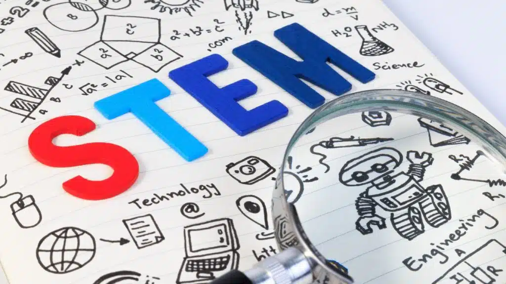 An image of the word STEM written on paper referring to coding robots for kids. 