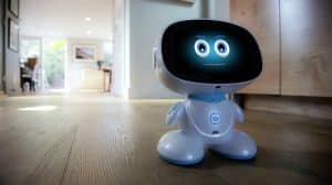 Misa Robot (Misa 2) with animated face display on a hardwood floor, designed as an AI-powered learning companion for kids aged 5–12 blending STEM education, voice interaction, and safe play.